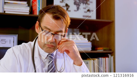 Physician working on his desk in clinic 4k Physician working on his desk in clinic 4k 121316916