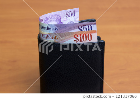 Cayman Islands dollar in the black wallet Cayman Islands dollar in the black wallet 121317066