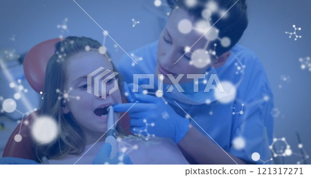Image of molecules over caucasian male and female dentists and girl patient 121317271