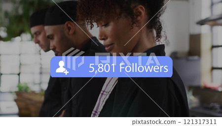 Image of followers growing number over african american female chef in reastaurant Image of followers growing number over african american female chef in reastaurant 121317311