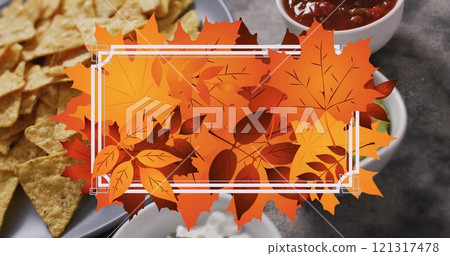 Image of frame with fall leaves over nachos with dips Image of frame with fall leaves over nachos with dips 121317478