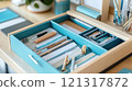 Teal desk organizer drawer with stationery and papers. 121317872