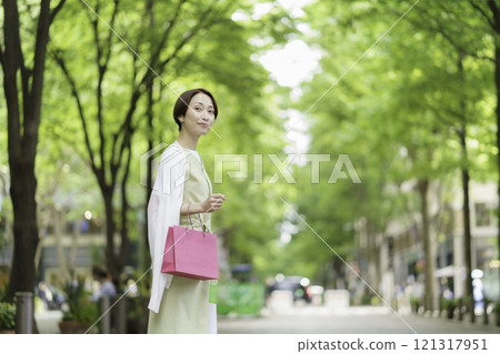 A middle-aged woman shopping in the fresh greenery 121317951