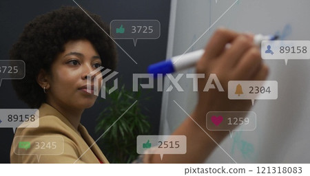 Image of icons and numbers over african american businesswoman writing in office 121318083