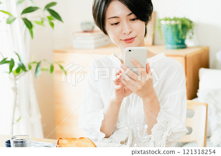 Young woman looking at a smartphone 121318254