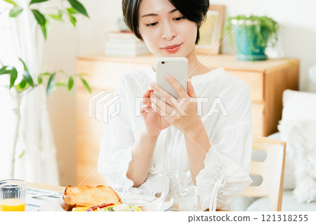 Young woman looking at a smartphone 121318255