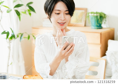 Young woman looking at a smartphone 121318259