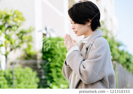 A woman in a coat walking outdoors A woman in a coat walking outdoors 121318333