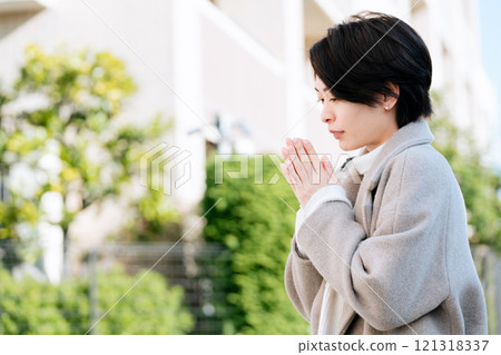 A woman in a coat walking outdoors A woman in a coat walking outdoors 121318337
