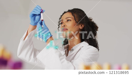 Scientist examining sample with molecular structure image overlaid Scientist examining sample with molecular structure image overlaid 121318695