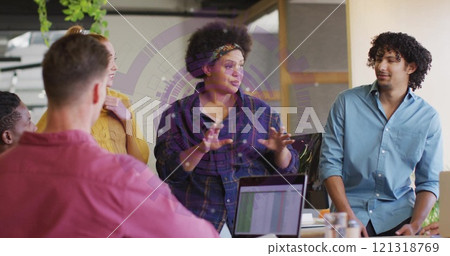 Discussing ideas, diverse team collaborating over image of graphs and charts Discussing ideas, diverse team collaborating over image of graphs and charts 121318769