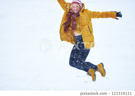 Young woman enjoying snow outdoor. 121319131