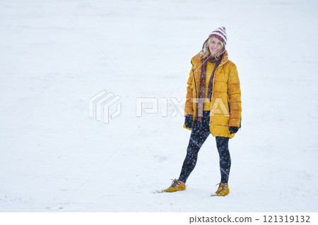 Young woman enjoying snow outdoor. 121319132
