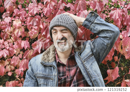 Man portrait in a checked shirt with an autumnal background Man portrait in a checked shirt with an autumnal background 121319252