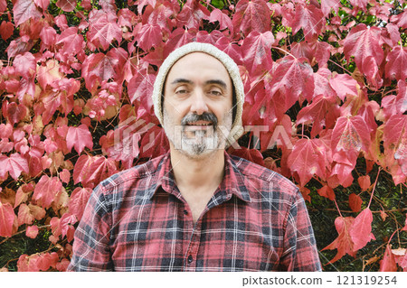 Man portrait in a checked shirt with an autumnal background Man portrait in a checked shirt with an autumnal background 121319254
