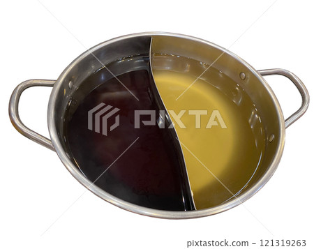 A stainless steel hotpot divided into two sections, containing two distinct broths: a dark, rich soup on one side and a lighter, golden broth on the other. A stainless steel hotpot divided into two sections, containing two distinct broths: a dark, rich soup on one side and a lighter, golden broth on the other. 121319263