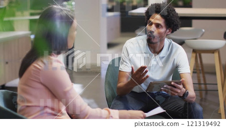 Image of financial data processing over diverse colleagues discussing work in office Image of financial data processing over diverse colleagues discussing work in office 121319492