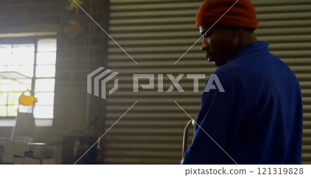 Male worker heating molds in workshop 121319828