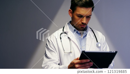 Doctor using digital tablet in corridor at hospital Doctor using digital tablet in corridor at hospital 121319885