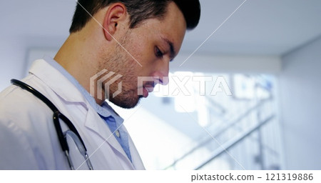 Doctor using digital tablet in corridor at hospital Doctor using digital tablet in corridor at hospital 121319886