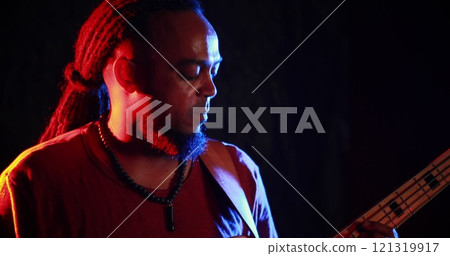 Guitarist playing electric guitar at nightclub 121319917