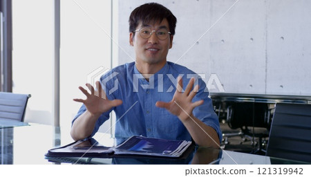 Front view of Asian male executive interacting in the office 121319942