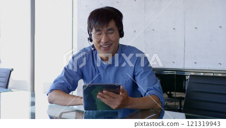 Front view of Asian male executive interacting in the office Front view of Asian male executive interacting in the office 121319943