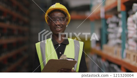 Portrait of an African American male factory worker at a factory making hydraulic equipment, wearing 121320004