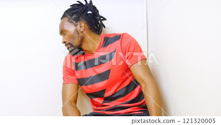 Frustrated athlete sitting alone in the locker room 121320005