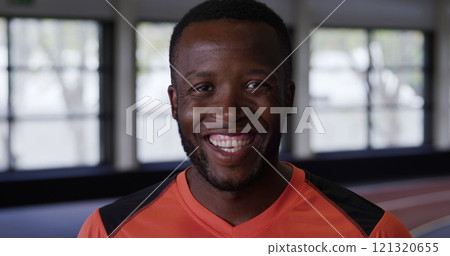 Portrait close up of an athletic African American man wearing sports clothes, smiling to camera duri Portrait close up of an athletic African American man wearing sports clothes, smiling to camera duri 121320655