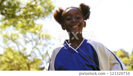 Portrait of smiling girl posing with football in park on a sunny day 4k Portrait of smiling girl posing with football in park on a sunny day 4k 121320710