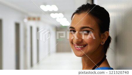 Portrait of female doctor standing in corridor in hospital Portrait of female doctor standing in corridor in hospital 121320740