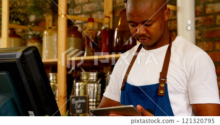 Male staff using digital tablet at counter in supermarket Male staff using digital tablet at counter in supermarket 121320795