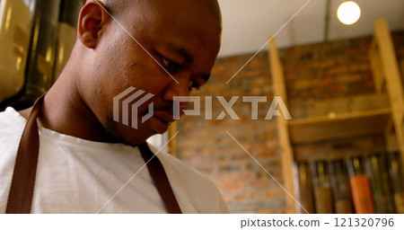 Low angle view of male staff using digital tablet in supermarket 121320796