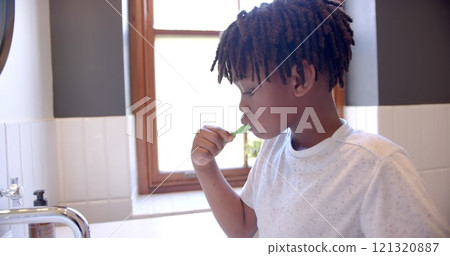 African american boy brushing teeth in bathroom at home, slow motion African american boy brushing teeth in bathroom at home, slow motion 121320887