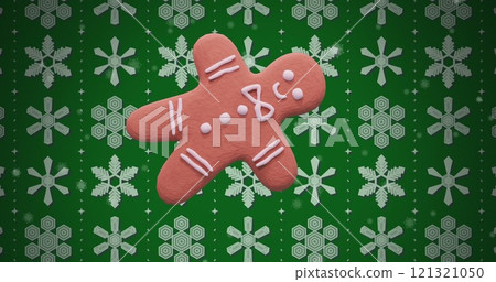 Image of ginger bread cookie over snow pattern on green background 121321050