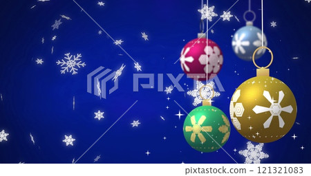 Image of baubles over snow falling on blue background 121321083