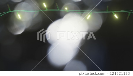 Image of flickering fairy lights over spots of light background 121321153