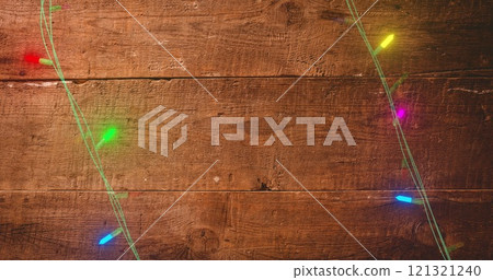 Image of fairy lights on wooden background 121321240