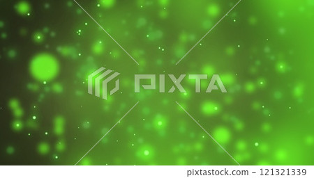 Image of snow falling over spots of light on green background 121321339