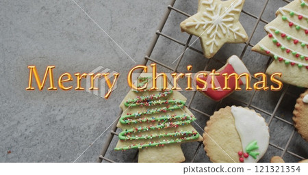 Merry christmas text in orange over decorated on christmas cookies Merry christmas text in orange over decorated on christmas cookies 121321354