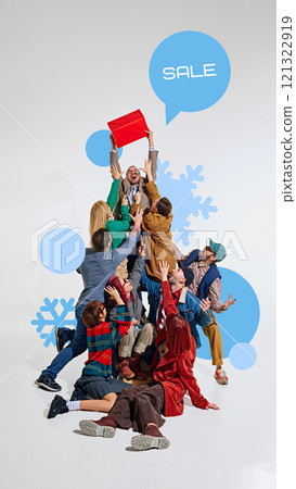 People energetically reaching for red gift box above them with SALE speech bubble, surrounded by snowflakes and winter elements. People energetically reaching for red gift box above them with SALE speech bubble, surrounded by snowflakes and winter elements. 121322919