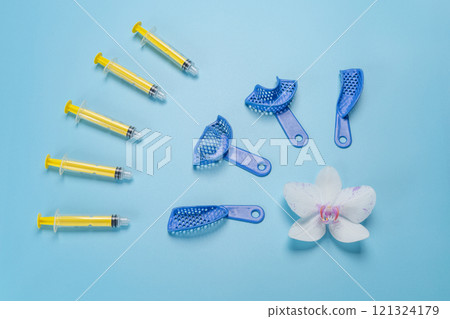 Set of dental pliant impression trays with syringes. Set of dental pliant impression trays with syringes. 121324179