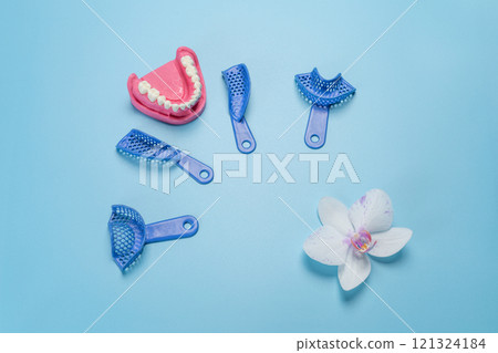 Set of dental pliant impression trays with a layout of the human jaw. 121324184