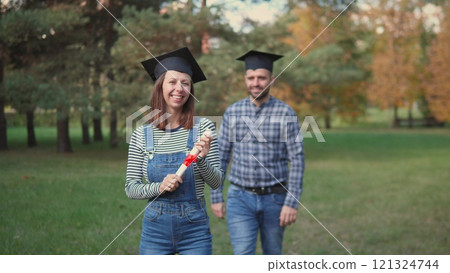 A truly joyous graduation moment has been beautifully captured in a lovely park surrounded by close friends 121324744