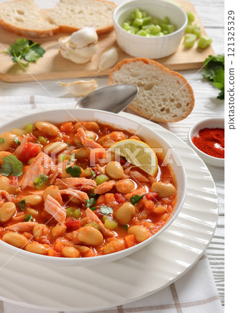 Pasulj, white bean soup with chicken in bowl 121325329