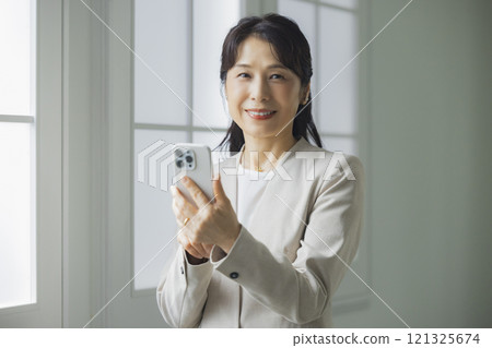 Business woman operating a smartphone 121325674