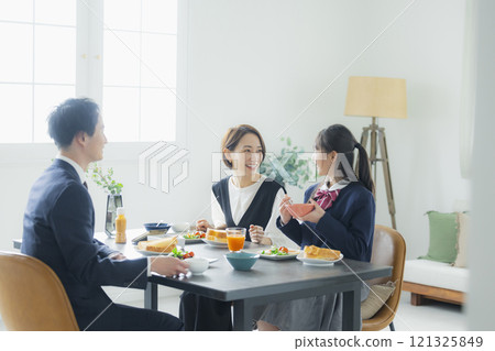 Image of a family having breakfast at the dinner table Image of a family having breakfast at the dinner table 121325849