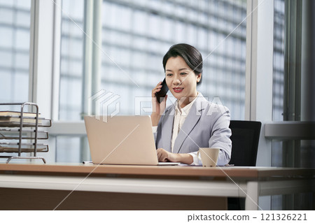 young asian business woman working in modern office 121326221