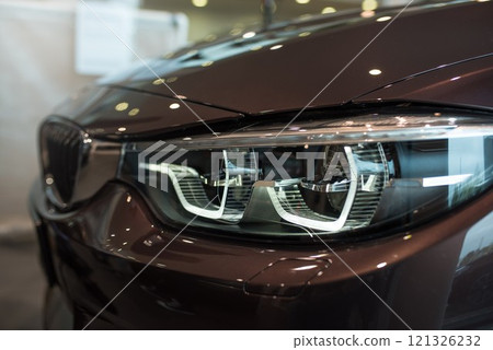 BMW car front lights, side view, brown paint, BMW showroom Wroclaw Poland, April 28, 2017 121326232